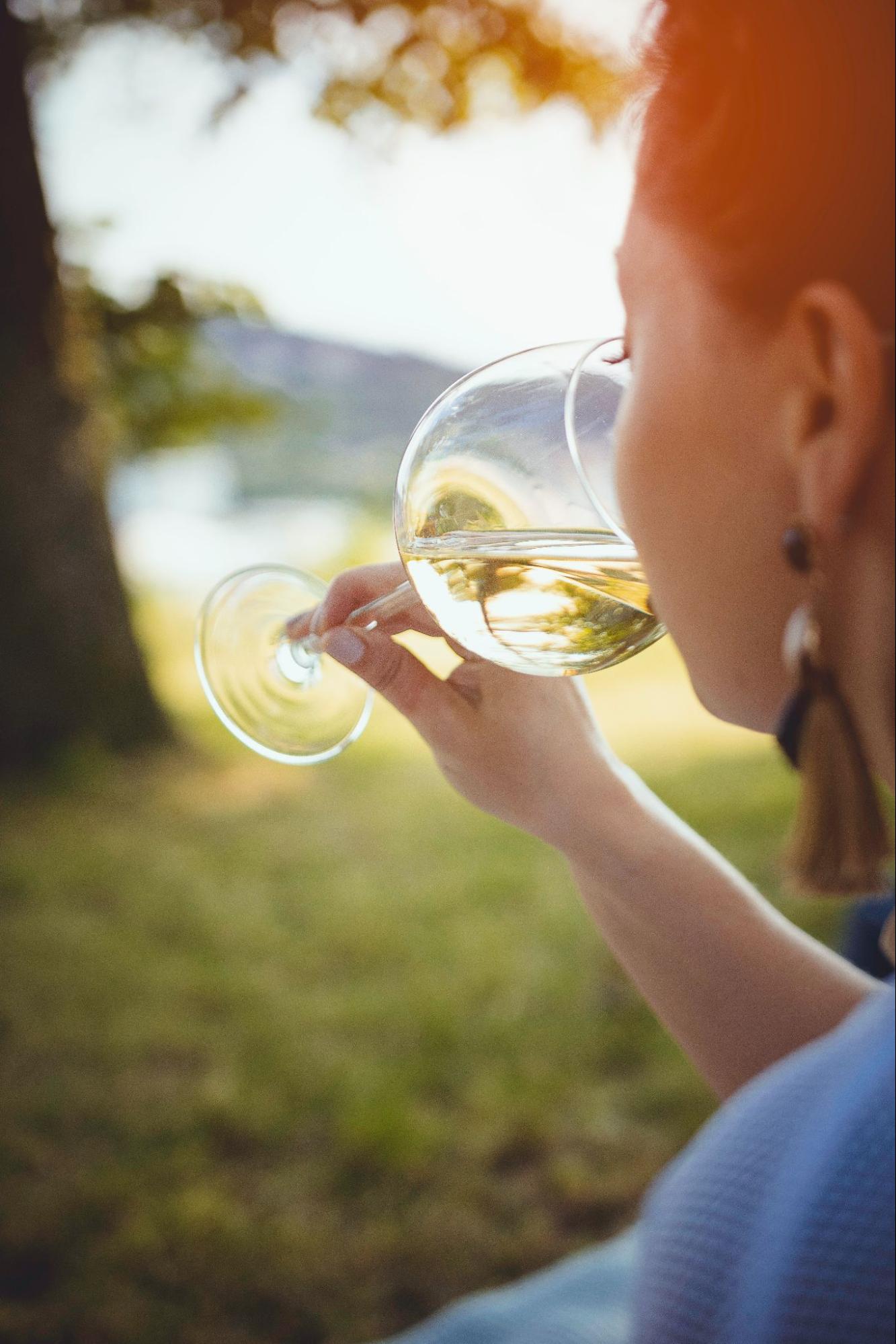 woman drinking a glass of white wine
